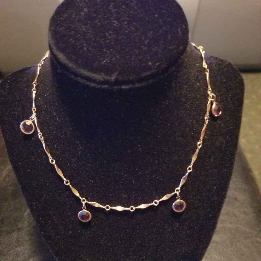 Gold tone garnet stone necklace.